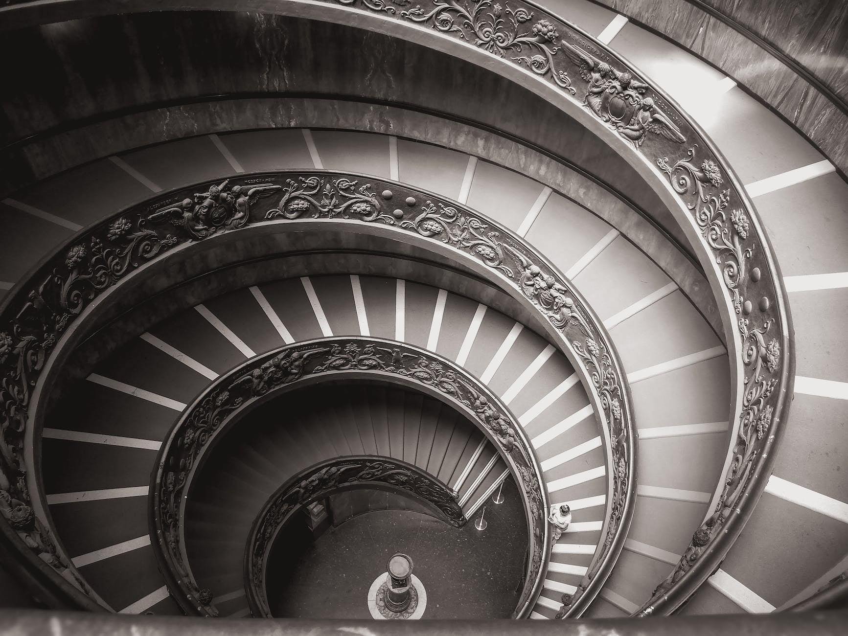 grayscale photo of momo spiral staircase in vatican city