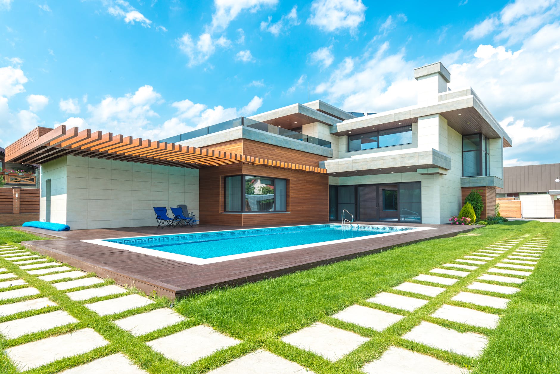 a modern house with swimming pool under the blue sky