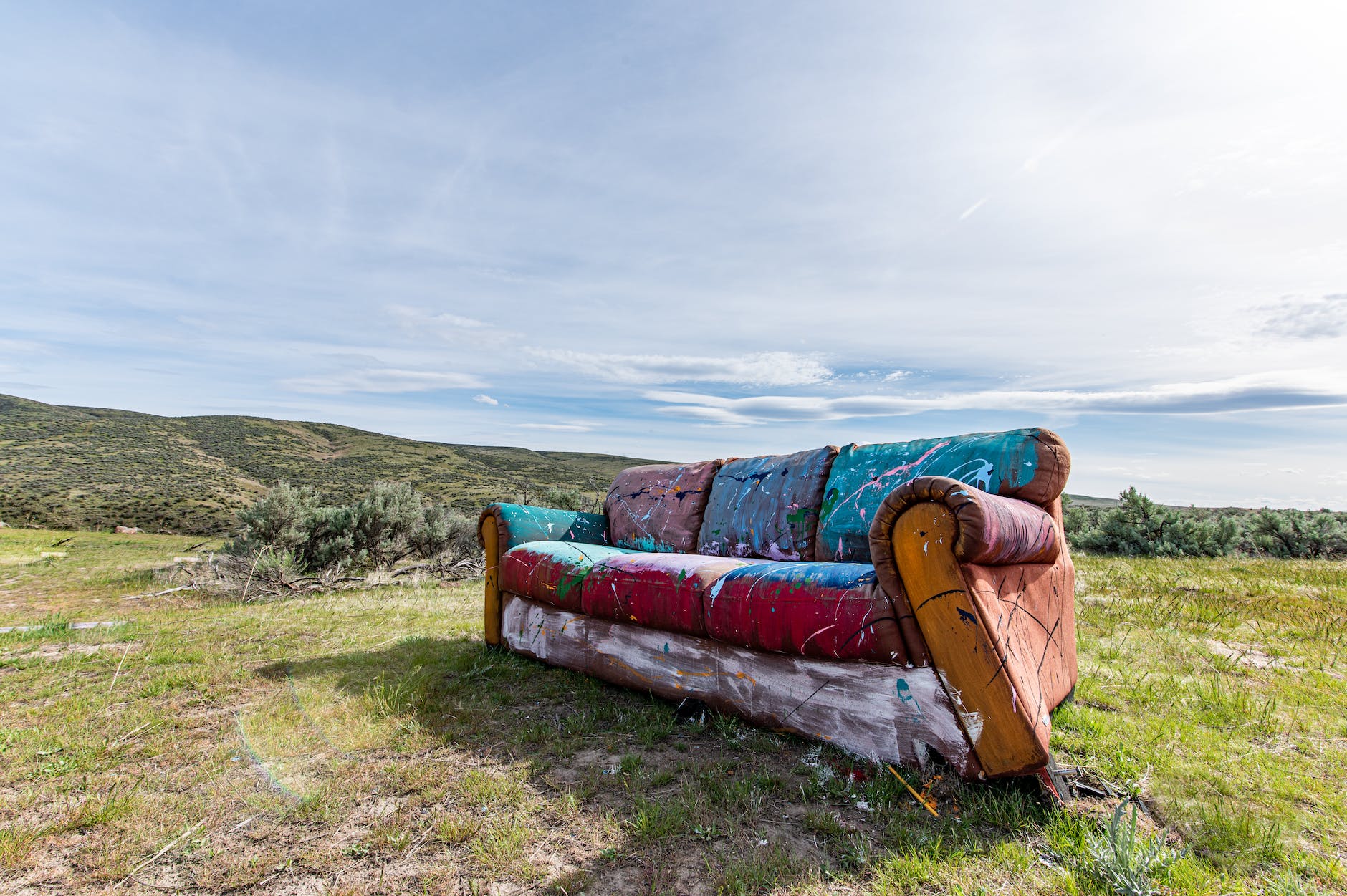 vintage abandoned couch on meadow in countryside