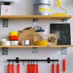tools and colours on shelves in painter workplace
