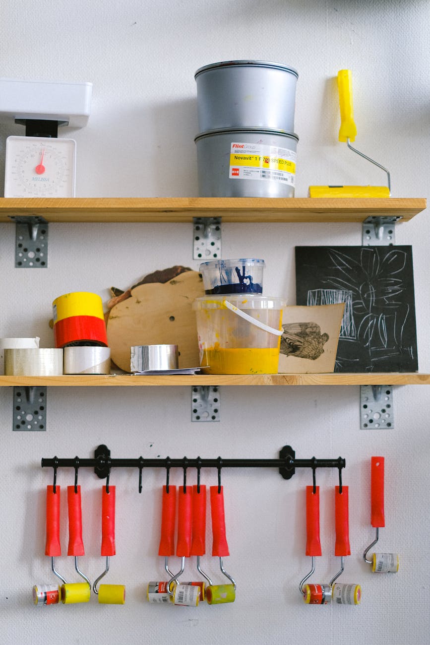 tools and colours on shelves in painter workplace