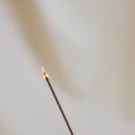 lighted incense stick on white background