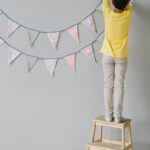 a person hanging a birthday banner
