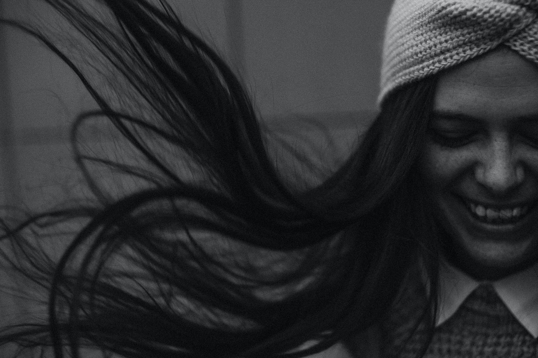 black and white photo of brunette in windy day