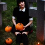 woman sitting holding pumpkin