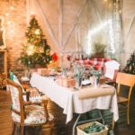 a dining table with chairs and table cloth during the christmas season