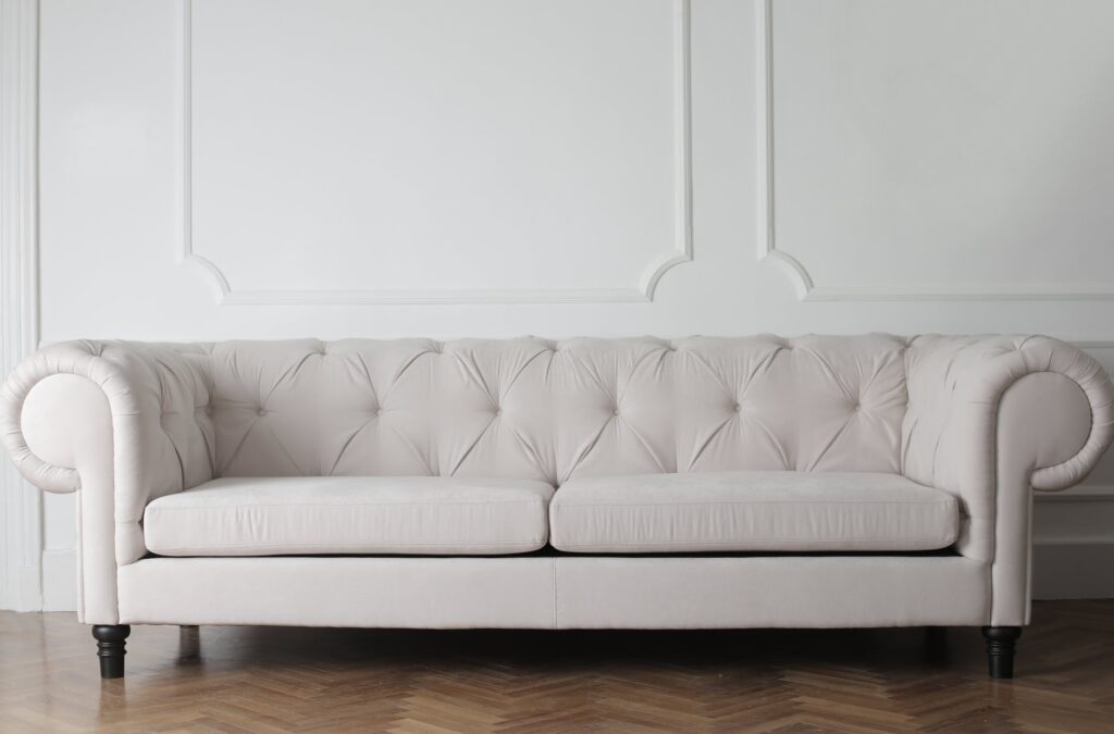 photo of white couch on wooden floor